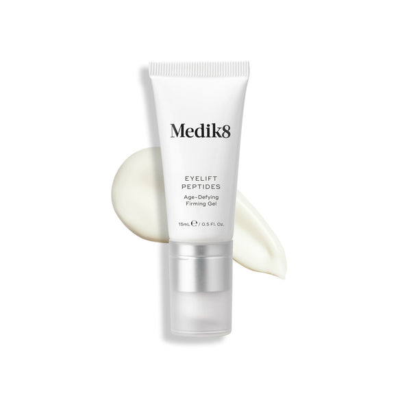 A tube of Eyelift Peptides stands upright, with a swatch of the product behind it.-5