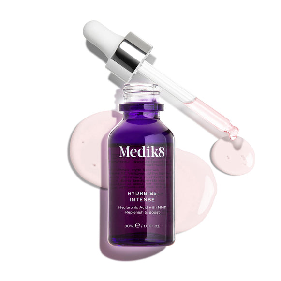 Medik8 Hydr8 B5 Intense glass dropper bottle in deep purple, shown with an open pipette resting above light pink serum droplets on a clean white background. Text highlights the formula as Hyaluronic Acid with NMF (Natural Moisturising Factors) to Replenish & Boost in a 30mL size.-9