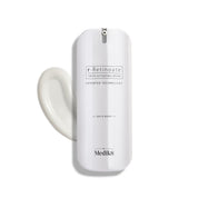 A sleek white pump bottle of r-Retinoate Day & Night stands upright, with a swirl of white cream next to it.