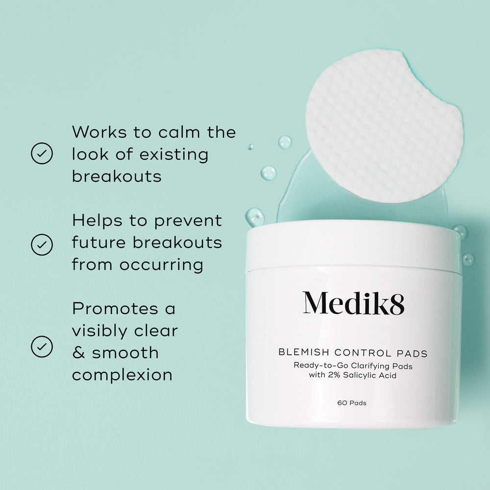 Medik8 Blemish Control Pads jar is shown against a light teal background with a single textured white pad and clear liquid droplets. Text highlights that the product  Works to calm the look of existing breakouts,   Helps to prevent future breakouts from occurring,  and  Promotes a visibly clear & smooth complexion. 