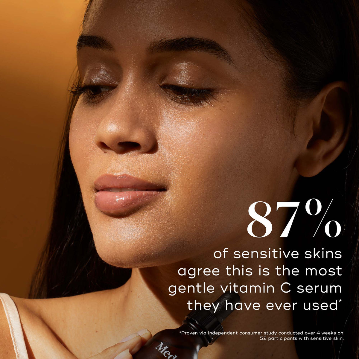 Close-up of a woman with a glowing, radiant complexion resting her hand on her cheek. Text states: "87% of sensitive skins agree this is the most gentle vitamin C serum they have ever used." Smaller text below notes results based on a consumer study.