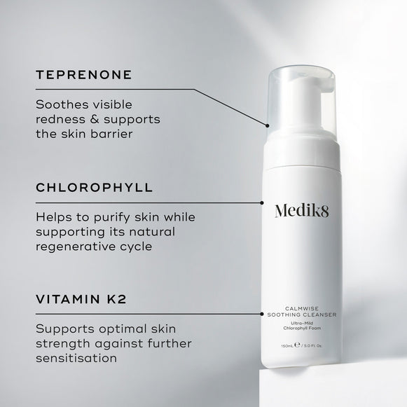 A Medik8 Calmwise Soothing Cleanser bottle displayed on a white block. Lines connect the bottle to text explaining key ingredients:  Teprenone  to soothe redness,  Chlorophyll  to purify skin, and  Vitamin K2  to support skin strength.-hover-9