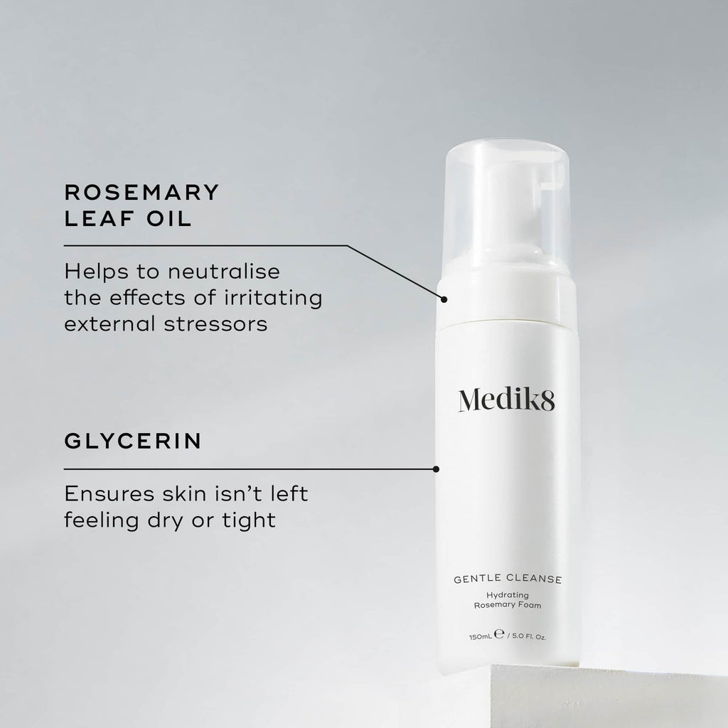 A Medik8 Gentle Cleanse bottle displayed on a white block. Lines connect the bottle to text explaining key ingredients: "Rosemary Leaf Oil" to neutralise the effects of irritating external stressors and "Glycerin" to ensure skin isn't left feeling dry or tight.