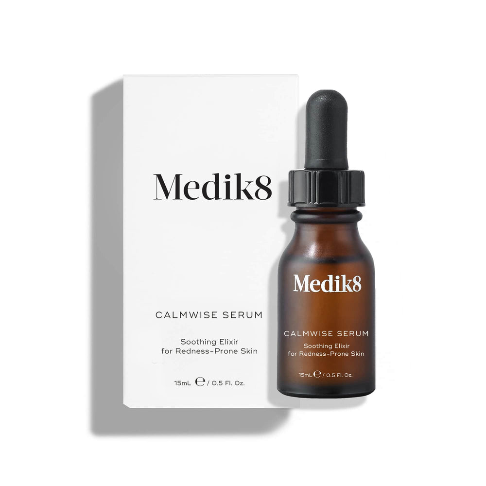 A glass dropper dispenses a single clear droplet of Calmwise Serum onto the palm of a hand, highlighting its lightweight, oil-free texture against a clean white background.