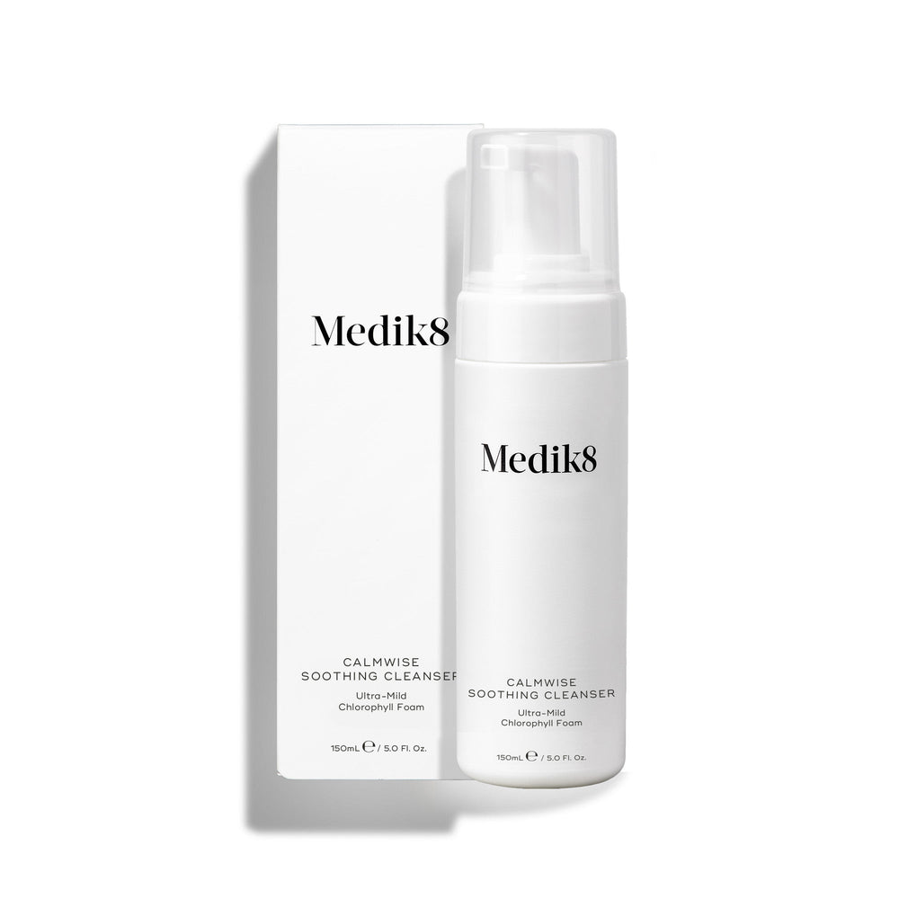 Medik8 Calmwise Soothing Cleanser pump bottle standing next to its white packaging box on a white background. Text identifies it as an  Ultra-Mild Chlorophyll Foam. 