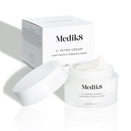 Medik8 C-Tetra Cream jar and its white cardboard carton displayed on a clean white background with soft shadows. The open white, frosted-glass jar features the Medik8 logo and is labeled  C-TETRA CREAM Lipid Vitamin C Radiance Cream  in a 50mL size. A thick swirl of white cream is visible on top of the jar, with the white box behind it showing the product name and a partial ingredients list.