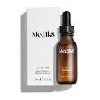 Medik8 C-Tetra Luxe serum bottle and its white cardboard carton displayed on a clean white background with soft shadows. The amber glass bottle and white box both feature the Medik8 logo and identify the product as  C-TETRA LUXE Lipid Vitamin C Enhanced Radiance Serum  in a 30mL size.