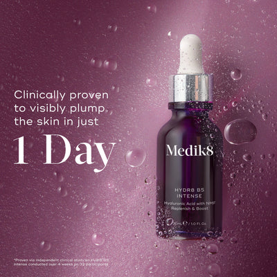 Medik8 Hydr8 B5 Intense glass dropper bottle centered on a shimmering purple background with translucent water droplets. Bold text states the product is clinically proven to visibly plump the skin in just 1 Day.