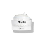 Medik8 Advanced Night Eye cream jar stands against a white background with the lid removed. The rich white cream is visible inside the jar, highlighting its texture.