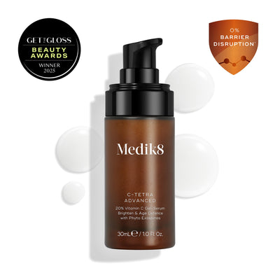 Medik8 C-Tetra Advanced bottle displayed on a clean white background with translucent serum droplets, highlighting its lightweight gel-serum texture.
