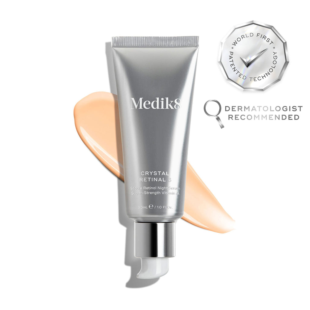 A silver tube of Crystal Retinal 6 is displayed, with a peach swatch to its side. A WORLD FIRST PATENTED TECHNOLOGY seal and a DERMATOLOGIST RECOMMENDED icon are shown. 
