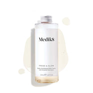 A 200mL clear refill bottle of Medik8 Press & Glow exfoliating tonic featuring a silver screw cap. Set against a white background, the bottle sits amidst a puddle and droplets of the pale yellow tonic, showcasing its liquid texture. The label text reads ""Daily Exfoliating PHA Tonic with Enzyme Activator."