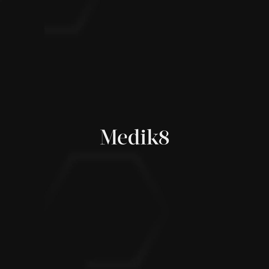 A jar of Medik8 Advanced Pro-Collagen+ Peptide Cream is featured against a sleek black background with a stylized DNA helix graphic. The video shows the cream being applied to a participant’s face, with text stating it helps to increase collagen production by 45%. A before-and-after side-by-side comparison demonstrates visibly smoother wrinkles after 7 days. High-tech graphics highlight key ingredients: Growth Factor MiniProtein™ and NAD+ Longevity Booster. The video ends with a close-up of the smooth cream